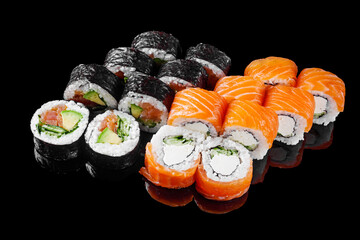 sushi roll with cream cheese salmon shrimp cucumber avocado set on a black mirror background