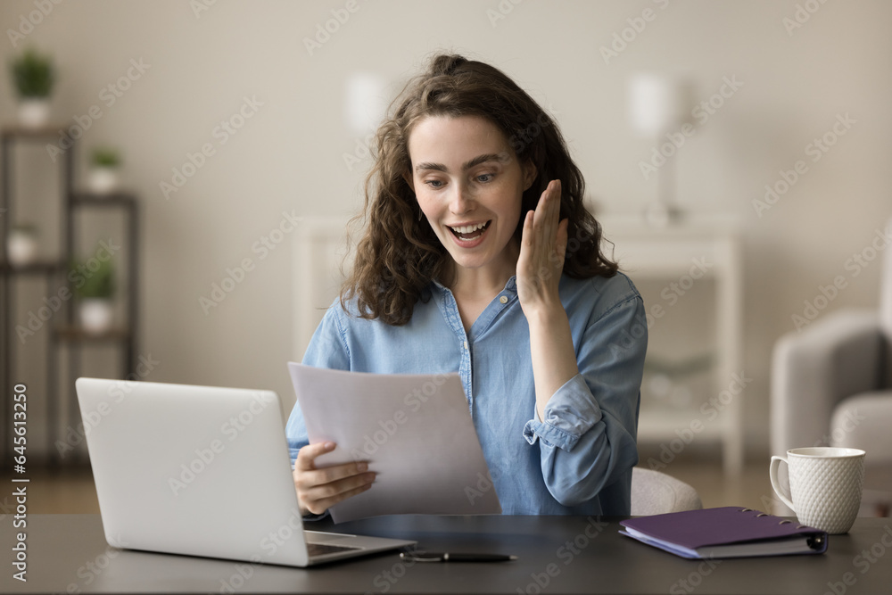 Wall mural happy freelance business woman celebrating project success, achievement, win, reading paper document