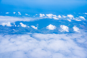 Background blue sky and white clouds seen from plane window. There is space for writing content. Natural sky, bright style.