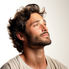 Professional studio head shot of a dreamy 30-year-old Middle Eastern boy, eyes looking up right.