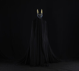 devil in a black cloak on a black background
