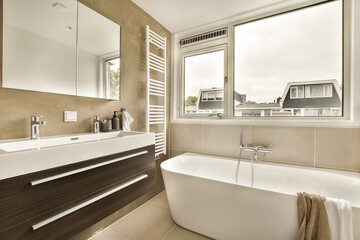 a bathroom with a bathtub, sink and mirror in the corner next to it is a window that looks out onto the street
