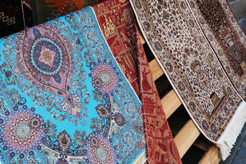 Colorful Turkish traditional rugs.Ethnic turkish carpets standing on the stand in front of the carpet shop in İstanbul.
