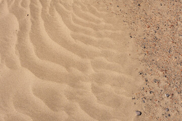 White sand beach. Beach of Famara. Texture of white sand and stones. Caleta de Famara, Lanzarote, Canary Islands, Spain.