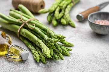 Bunch of raw asparagus stems with different spices