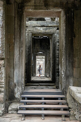 girl through the infinite gates of the Angkor Wat temples