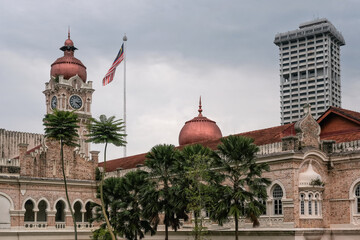 Fototapeta na wymiar View of Sultan Abdul Samad Building and Malaysian flag on cloudy day. Kuala Lumpur, Malaysia.
