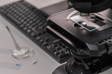 Doctor or scientist hand on Microscope and Scientific Equipment in a Research Laboratory. Specialists Working on Medicine, Biotechnology Research in Advanced Pharma Lab. Concept of research healthy.