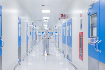 Focus chemistry man with biochemistry suit at the Walkway in the spacious and bright laboratory...