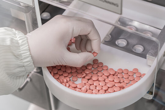 Macro Shot of colour Pills and Capsules During Production and Packing Process on Modern Pharmaceutical Factory. Tablet and Capsule Manufacturing Process. Close-up Shot of Medical Drug Production Line.