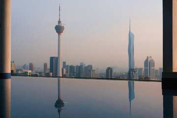 View of Kuala Lumpur from roof top swimming pool on sunny evening, Malaysia.