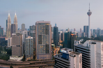 View of the city, Petronas Twin Towers and Kuala Lumpur Tower in the evening. Kuala Lumpur, Malaysia.