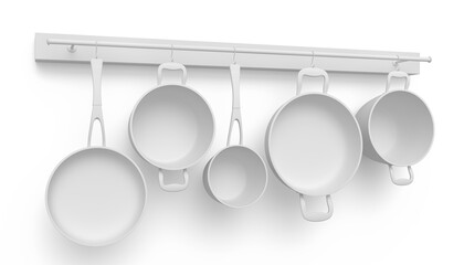 Set of stewpot, frying pan and chrome plated cookware hanging on shelf on white