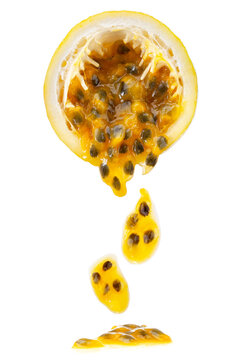 half of ripe yellow passionfruit with mixed tasty pulp isolated on white background.