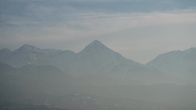Alatau mountains view from Almaty with fogy haze