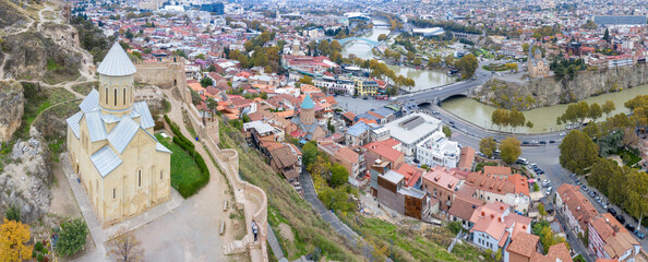 Aerial view of Saint Nicholas's Church, Narikala Fortress and Old Town on cloudy day. Tbilisi, Georgia. - obrazy, fototapety, plakaty