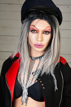 Drag queen. A young attractive guy in costume poses in a nightclub.
