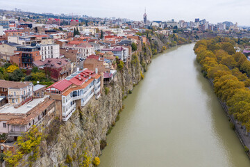 Aerial view of Old town and Kura river on cloudy day. Tbilisi, Georgia.