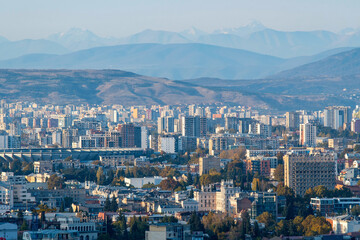 Tbilisi on the background of Caucasus Mountain Range on sunny autumn day. Georgia.
