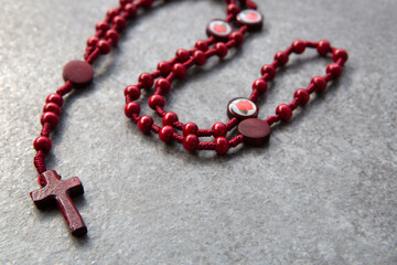 Red rosary on a stone background