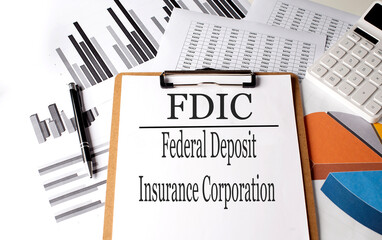 Paper with FDIC federal deposit insurance corporation on a chart background, business