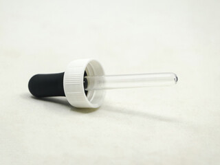 closeup shot of a plastic eye dropper pipette tool used for medical and scientific purposes isolated in a white background