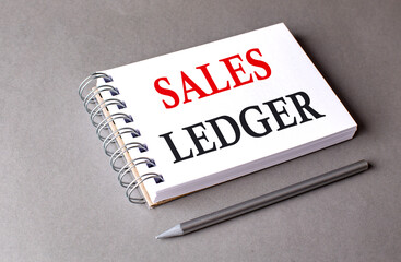 SALES LEDGER word on notebook on grey background