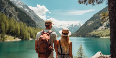 Deurstickers Travelers couple look at the mountain lake. Travel and active life concept with team. Adventure and travel in the mountains region in the Austria © Sasint