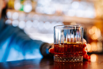 bartender hand making cocktail in bar