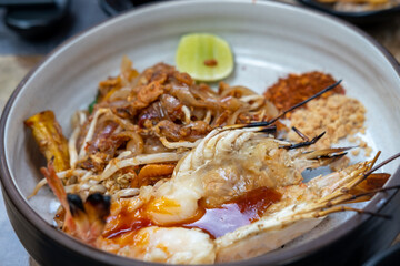 Pad Thai with river prawn serve on plate. It is a stir-fried rice noodle thai dish