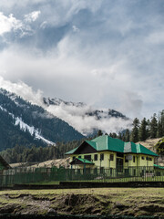 Fototapeta na wymiar Mountain house in kashmir valley with hill peaks.