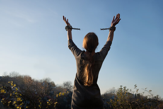 Close up jail law danger fear young lady ask god power help hope drug aid victory life sun text space. Closeup mental limit addict bind steel metal lock raise restrain will abuse kidnap crime forgive