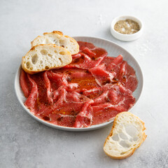 Traditional beef carpaccio with baguette bread