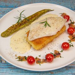 FISH RECIPE, SAINT-PIERRE SEAFISH, FILLET ACCOMPANIED BY PANNE RICE, THAI AUBERGINE, TOMATO, SHALLOT, TARRAGON AND CREAMY SAUCE WITH MUSTARD AND LEMON. High quality photo