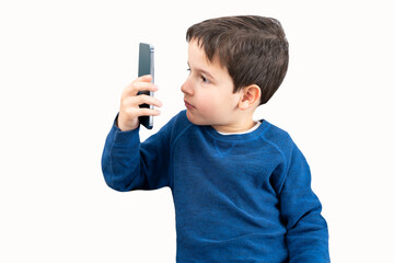 Boy suffering from eyestrain trying to message on a smart phone with white background.