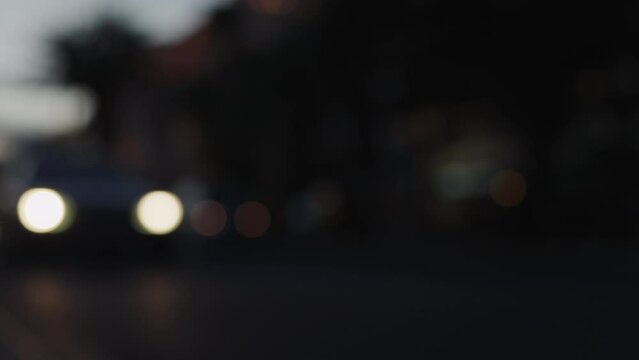 Blurred background of cars driving on a street after sunset