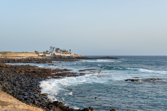 Afternoon vistas over the western coast of the island with roughed shores and frothy waves, a promenade connecting the small coastal villages and lots of banana farms, Tenerife, Canary Islands, Spain