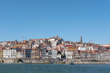 Fototapeta na wymiar Views from Douro River towards the northern bank featuring the distinctive and authentic local architecture of the waterfront neighborhood, the Ribeira district in Porto, Portugal