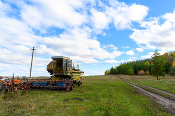 Fototapeta premium Abandoned combine harvester. Rusty spoiled combine harvester.