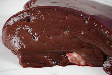 Fresh beef liver on a white background