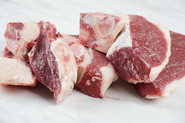 Fresh raw beef steaks with bone on cutting board ready for cooking Asado