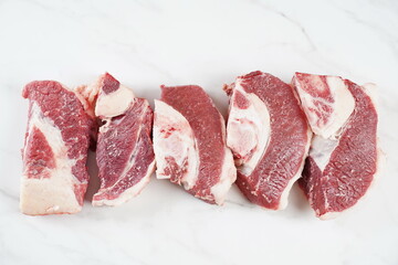 Fresh raw beef steaks with bone on cutting board ready for cooking Asado