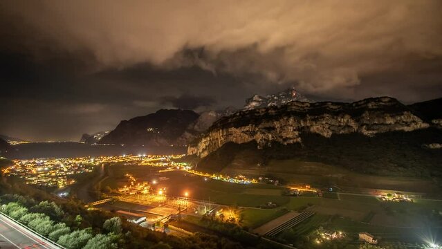 Night timelapse of the city in the mountains in Italy