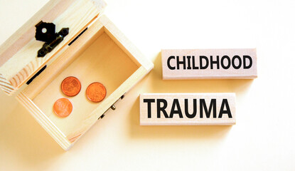Childhood trauma symbol. Concept words Childhood trauma on beautiful wooden blocks. Beautiful white...