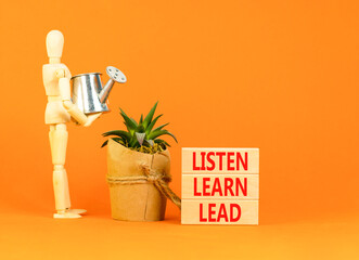 Listen learn lead symbol. Concept word Listen Learn Lead on beautiful wooden block. Businessman model. Beautiful orange table background. Business, education listen learn lead concept. Copy space.