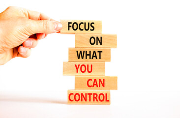 Focus on control symbol. Concept words Focus on what you can control on wooden block. Beautiful white table white background. Businessman hand. Business control motivational never stress concept.