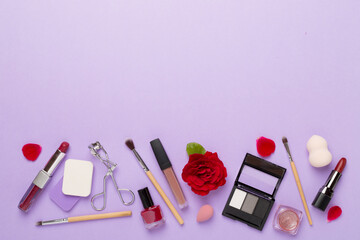 Obraz na płótnie Canvas Flat lay with makeup products and tools with flowers on color background