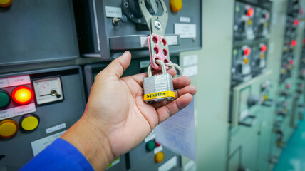 Lockout Tagout or LOTO. A key used to disconnect the energy system to ensure operator safety. Industrial safety concepts - obrazy, fototapety, plakaty
