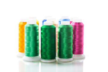 set of different color sewing threads,on white background.