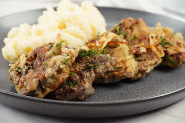 Fried beef liver with mashed potatoes and fried onions